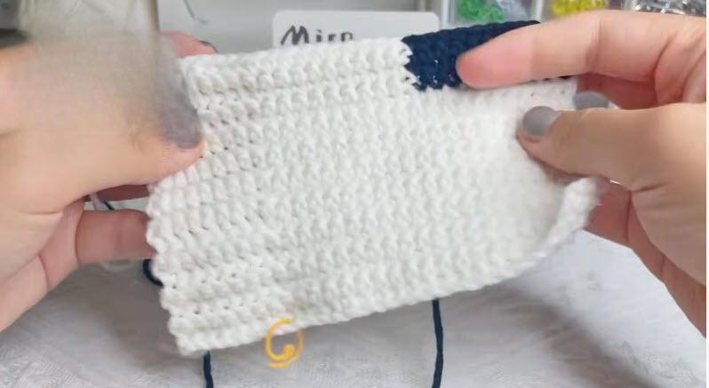 Finished glove panel with a navy contrast cuff edge
