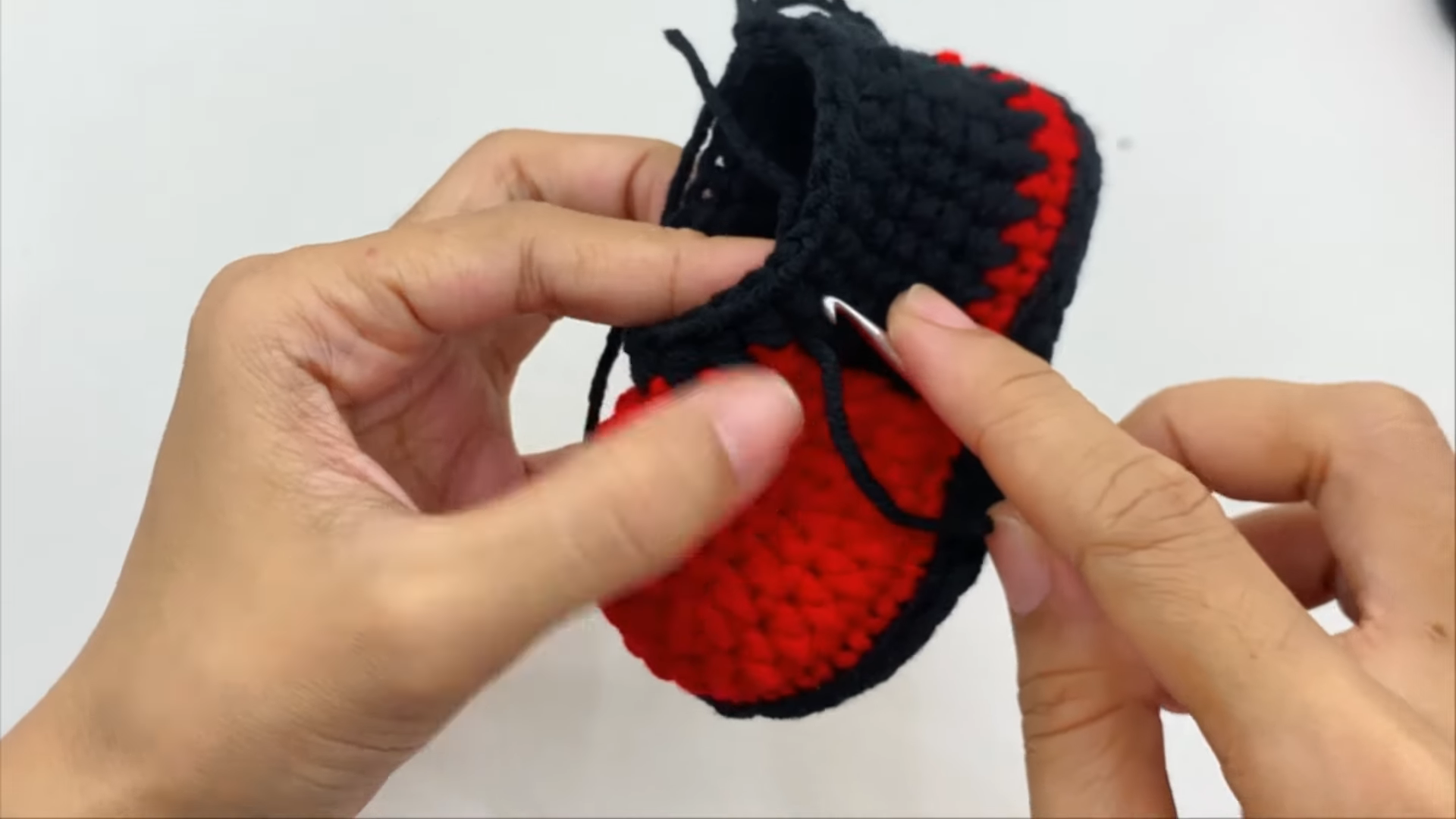 Black bootie with pink red details stitched
