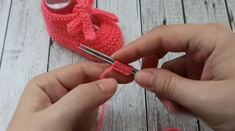 Cast on stitches on knitting needle for baby bootie