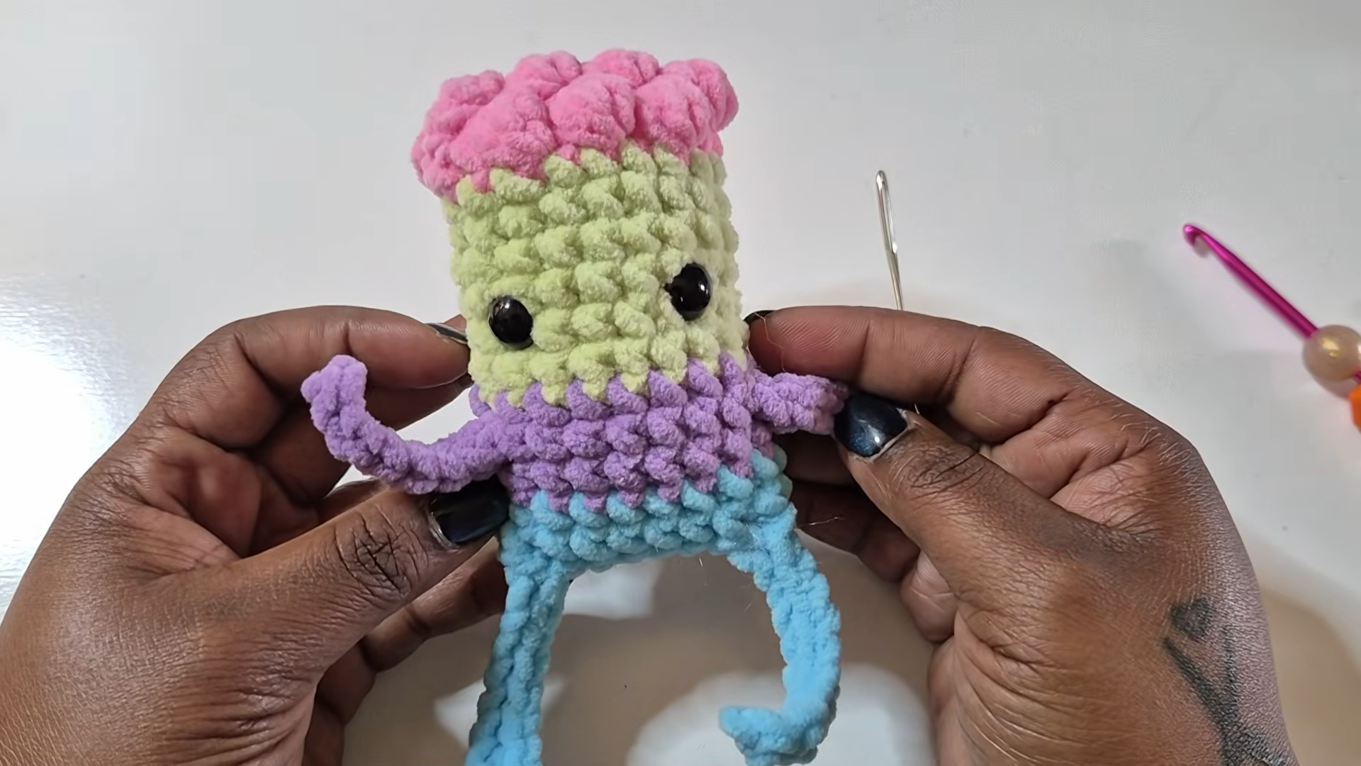 Colorful crochet zombie with bead eyes and arms
