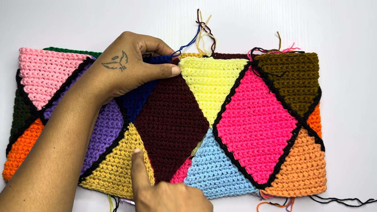 Colorful triangles joined with black yarn seams