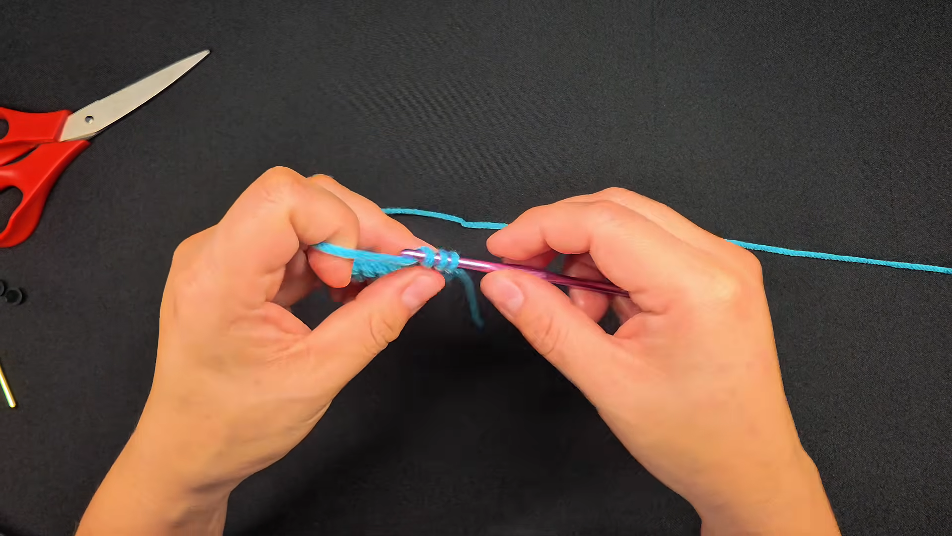 Crocheting first stitch with turquoise yarn
