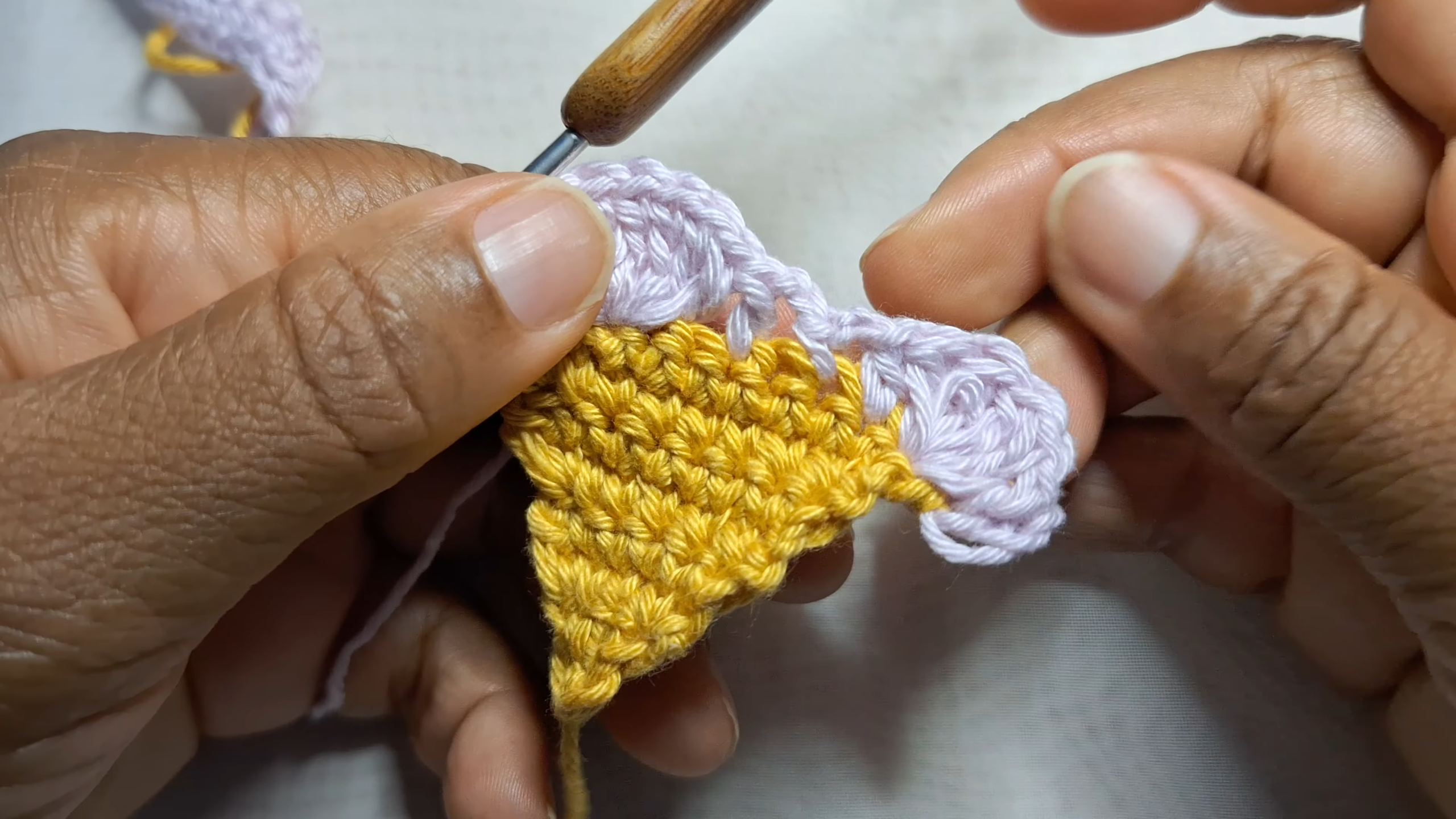 Crocheting pink flower center on turquoise headband