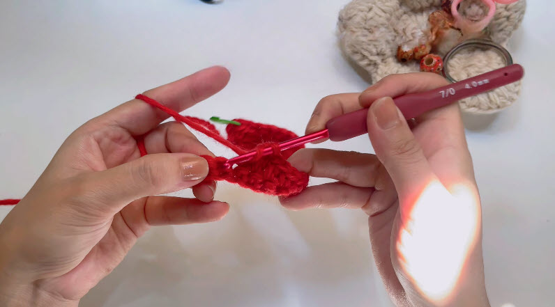 Crocheting mixed stitch pattern in red yarn