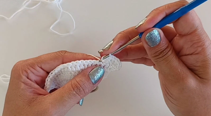 Crocheting rows into a white top panel.