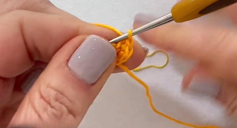 Crocheting yellow amigurumi duck beak piece