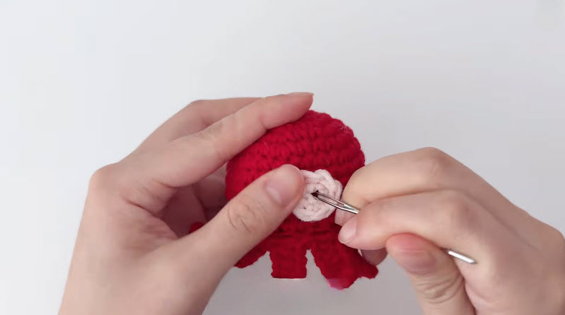 Gluing mouth onto crochet octopus keychain