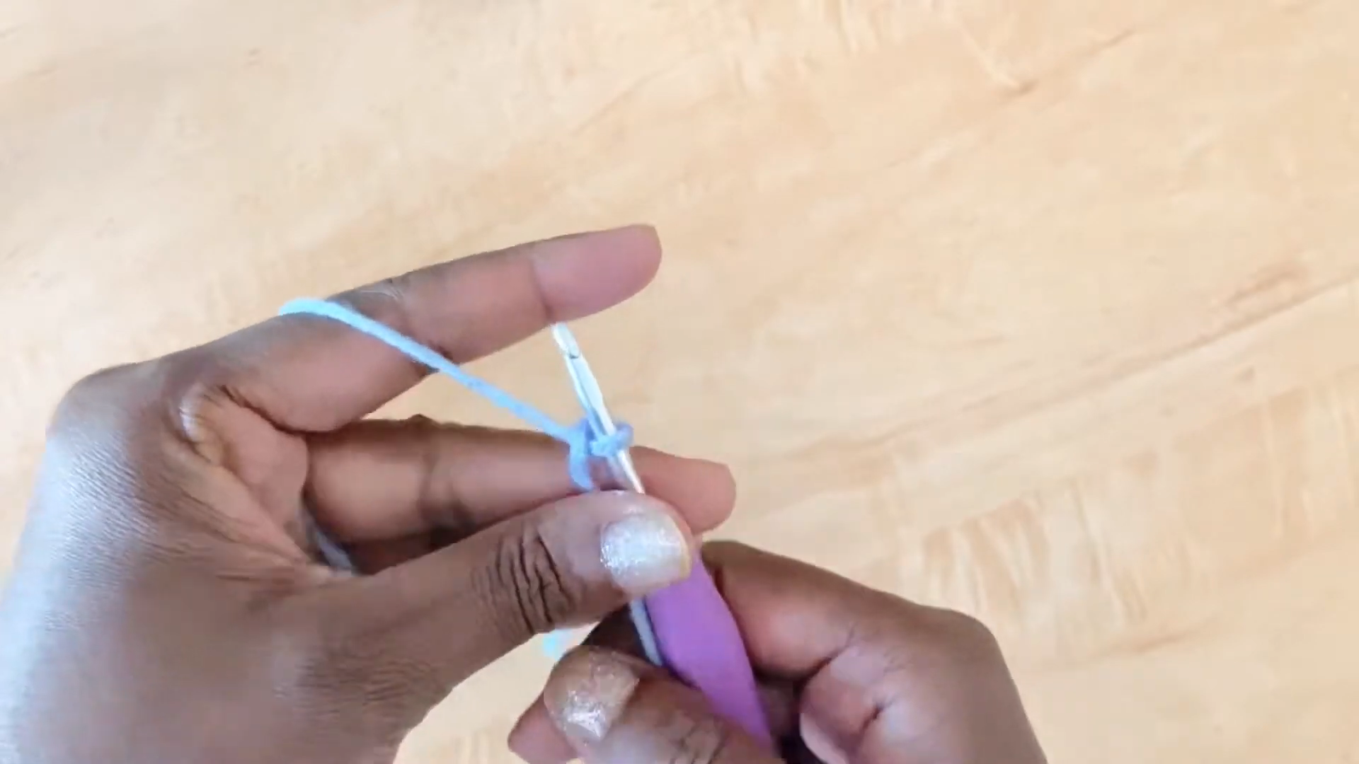 Making a slip knot with blue crochet yarn