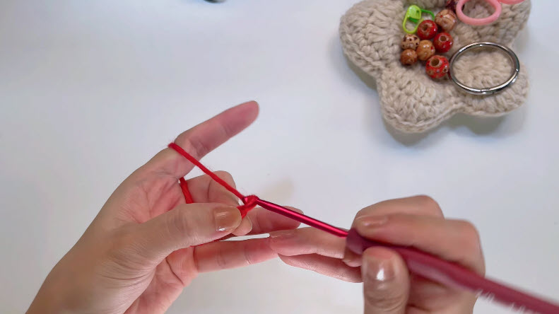 Making a slip knot with red crochet yarn