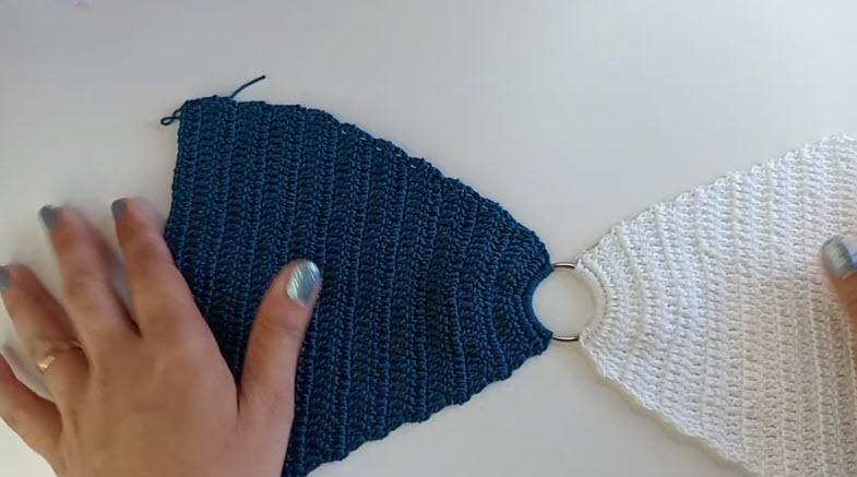 Navy and white triangle panels joined by a ring.