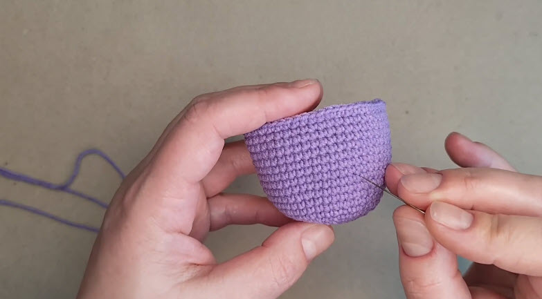 Needle marking the eye positions on the purple body.