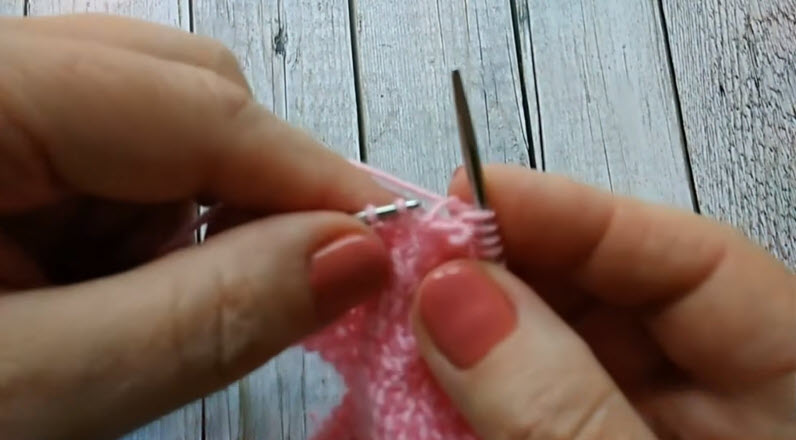 Pink knit stitches worked on thin needle