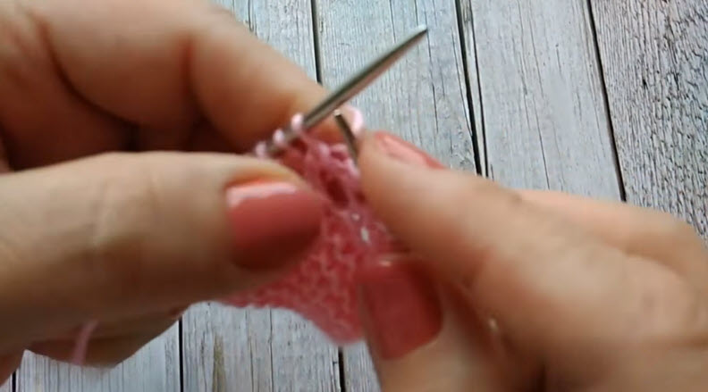 Pink lace pattern knit stitches close up