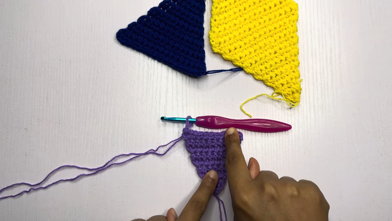Small purple triangle motif with hook