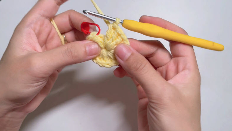 Star shape forming in yellow crochet basket