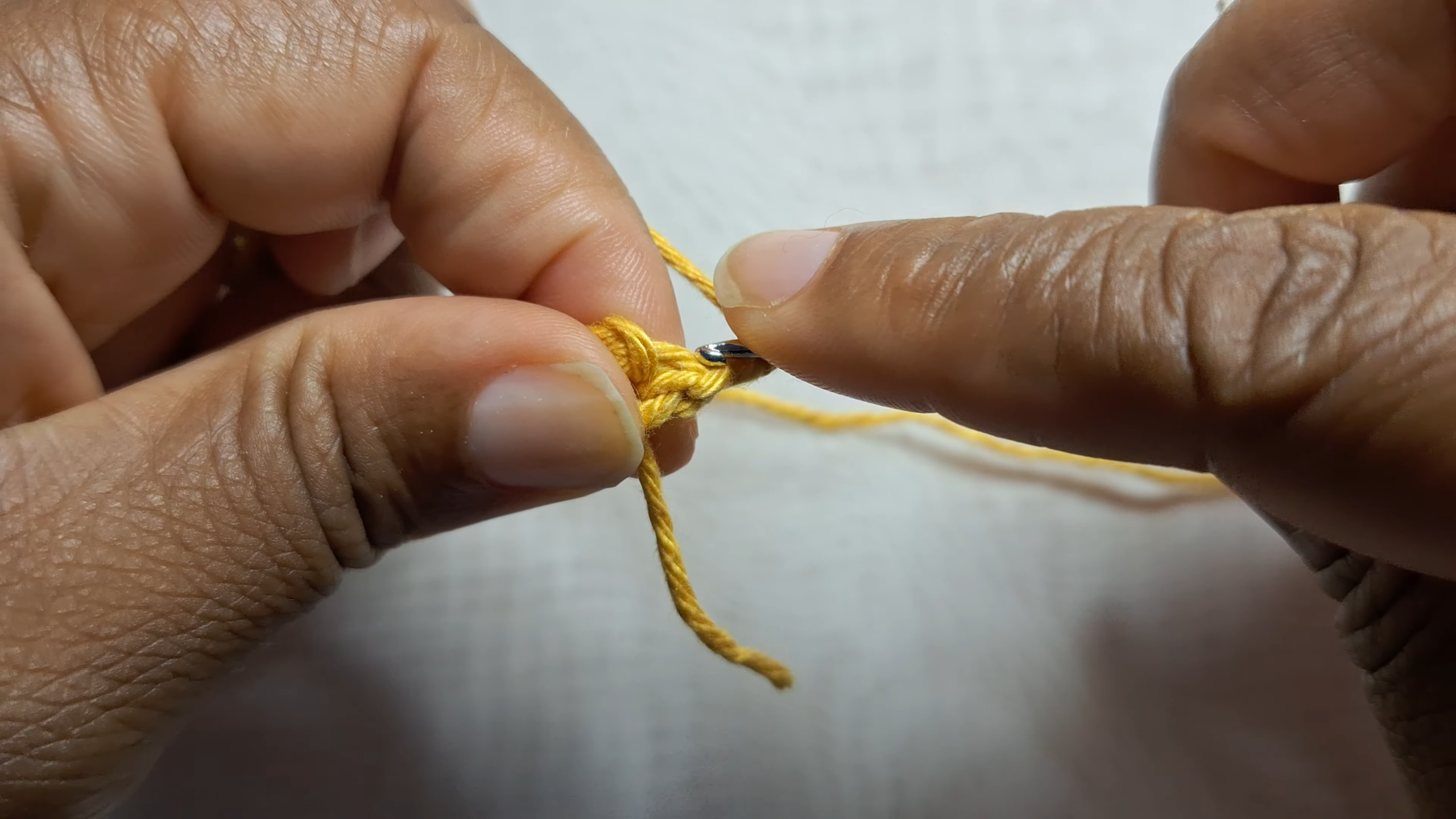 Starting a chain stitch with yellow yarn