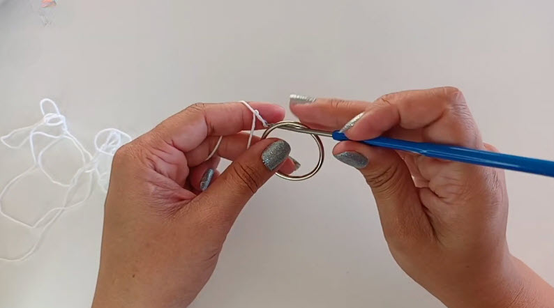 Starting a ring with white crochet thread and a hook.