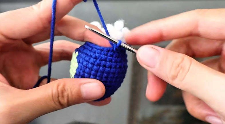 Stuffed blue body decreasing to 20 stitches.
