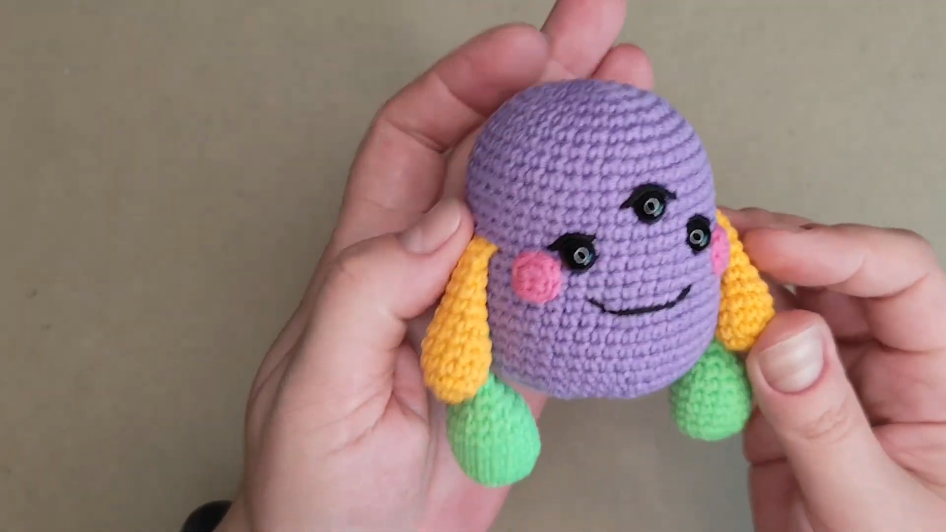 Free crochet monster pattern body with yellow arms and green feet.