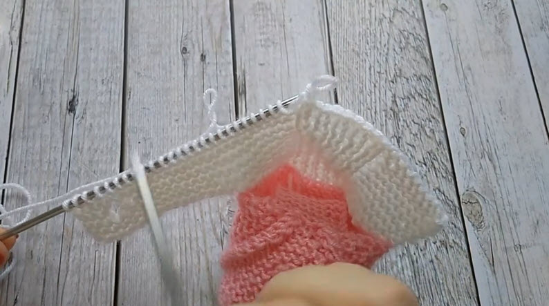 White and pink knit rows joined on needle