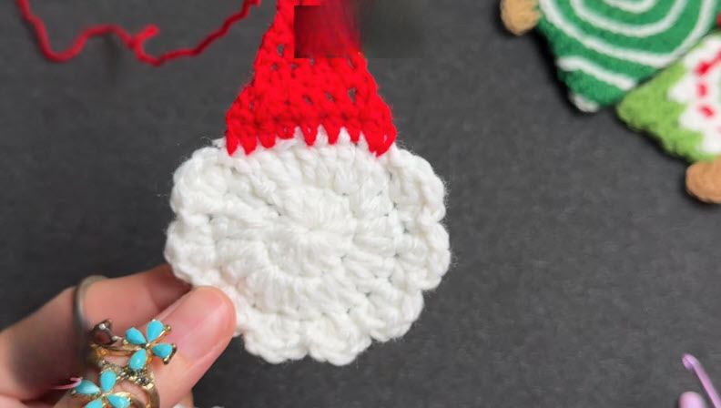 White and red crochet Santa hat piece ready for gluing.