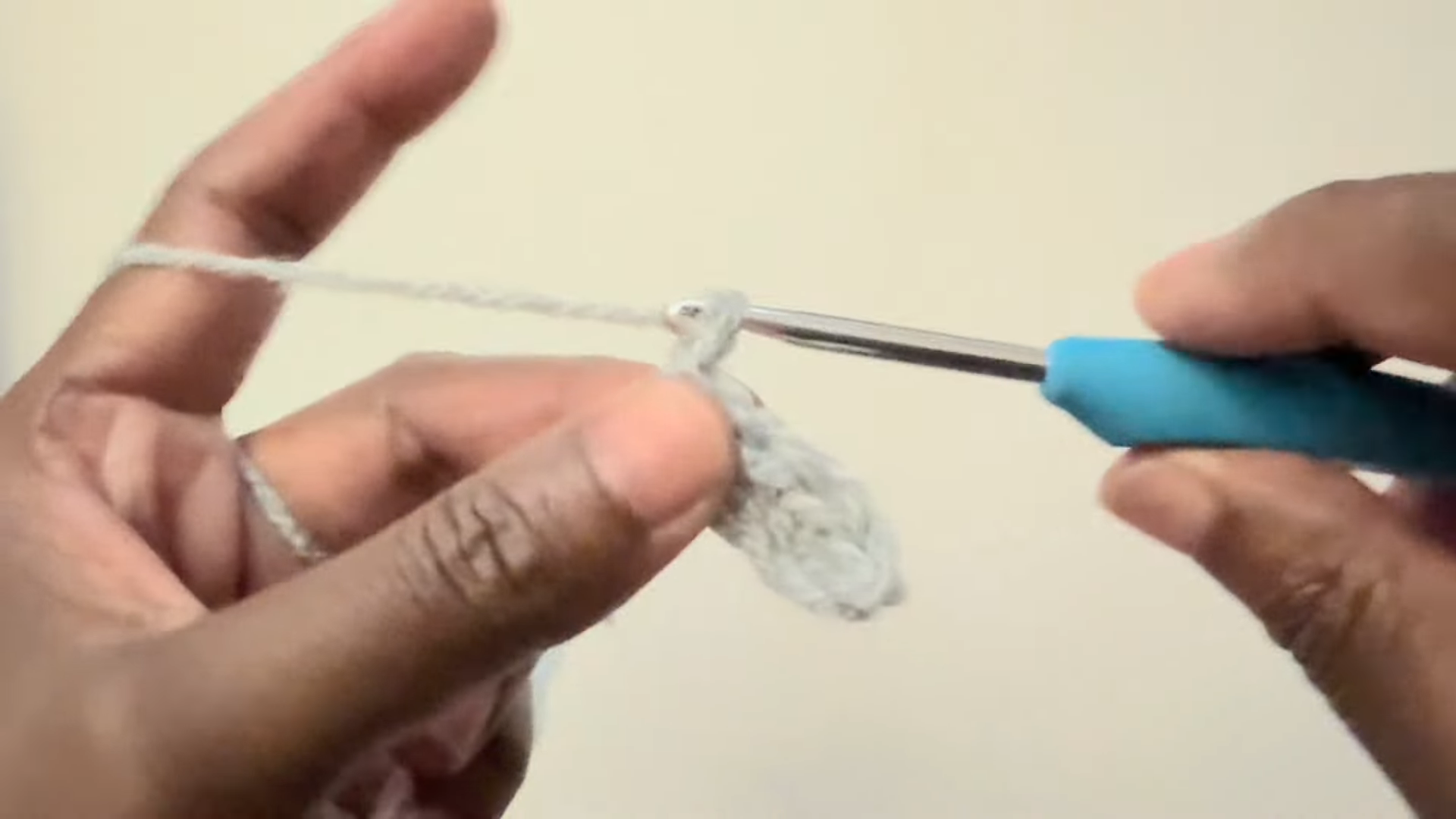 Working chain stitches with blue crochet hook