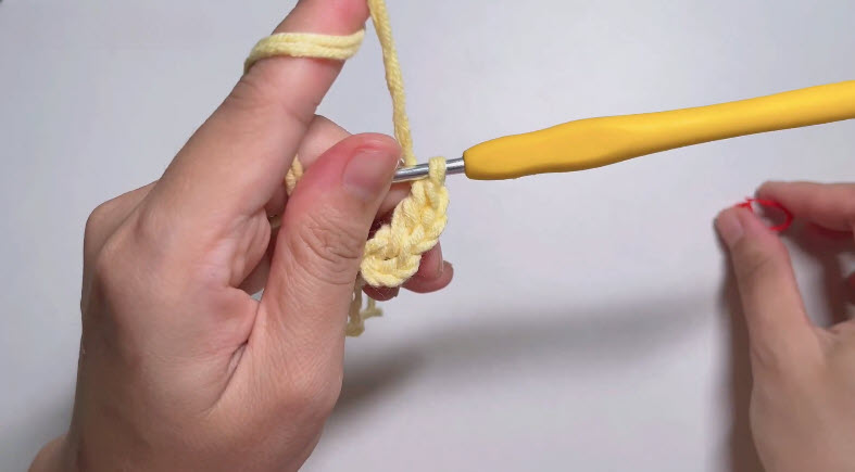 Working double crochet stitches in yellow yarn