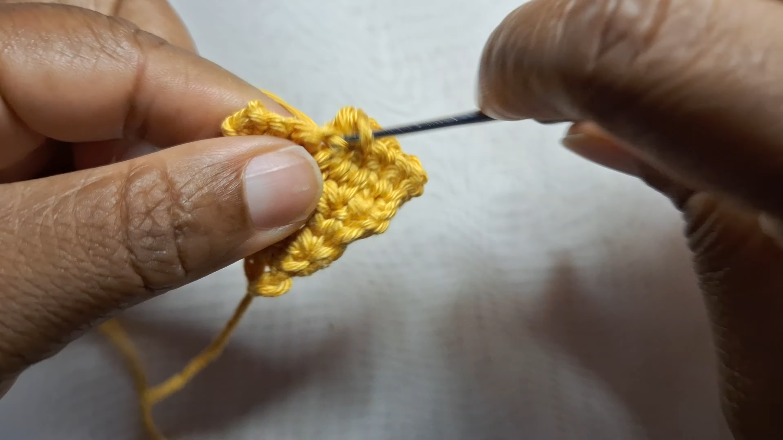 Working single crochet in yellow yarn cone shape