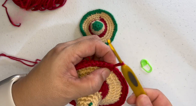Red round added on the cream band of the crochet sombrero
