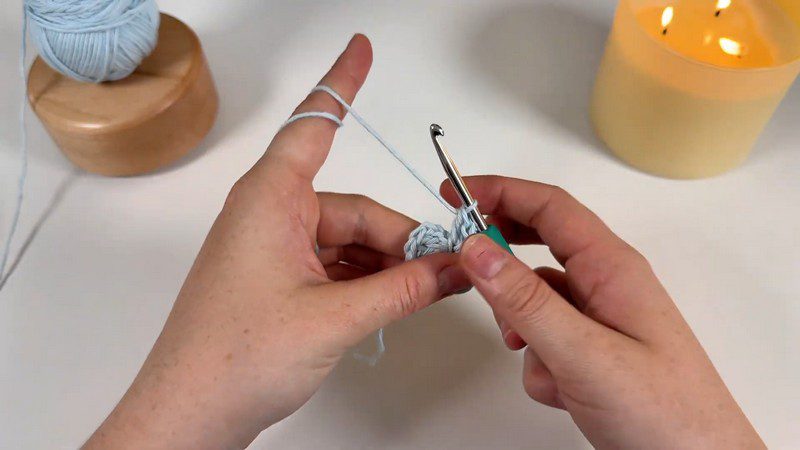 Crocheting the first stitches with light blue yarn