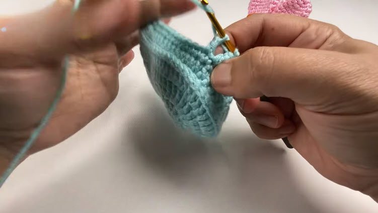Decreasing stitches together to start shaping the blue bootie sides.