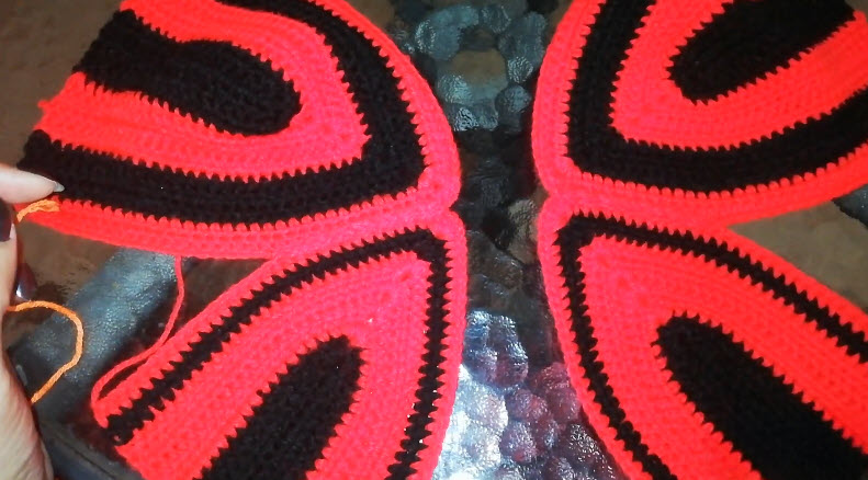 Four red and black petal shapes laid flat side by side.