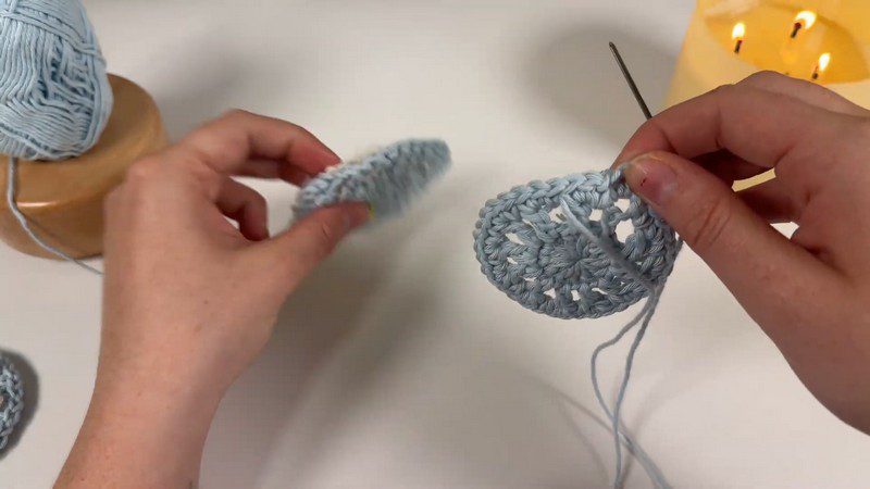 Joining the two blue circles with a needle.