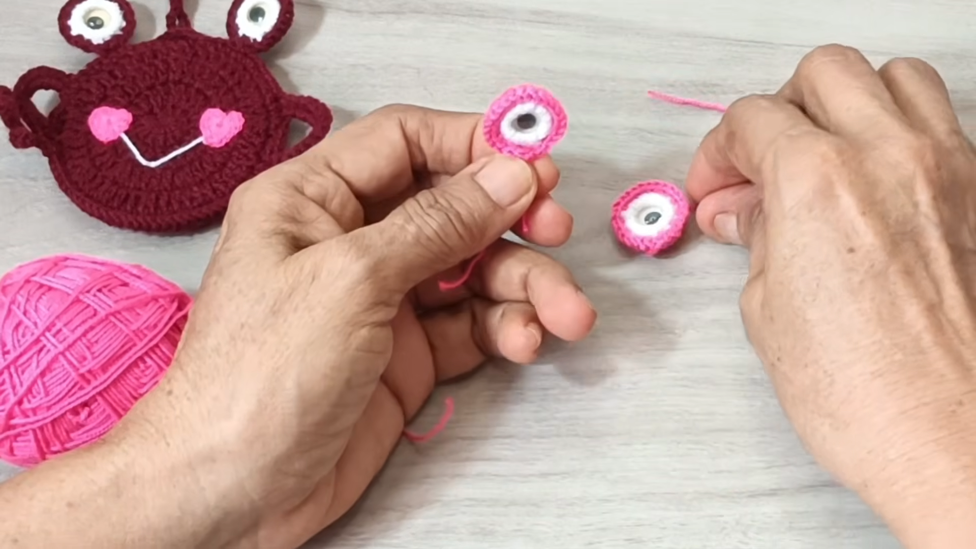 Showing two pink eyes with googly eyes inside.
