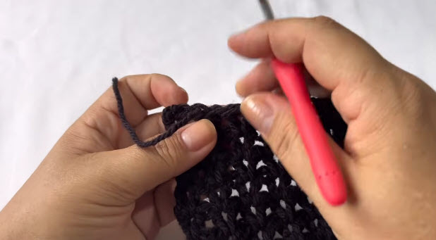 Starting a new row with black yarn using the red hook.