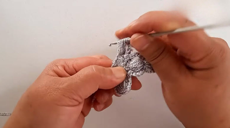 Puff stitch forming the first cross arm