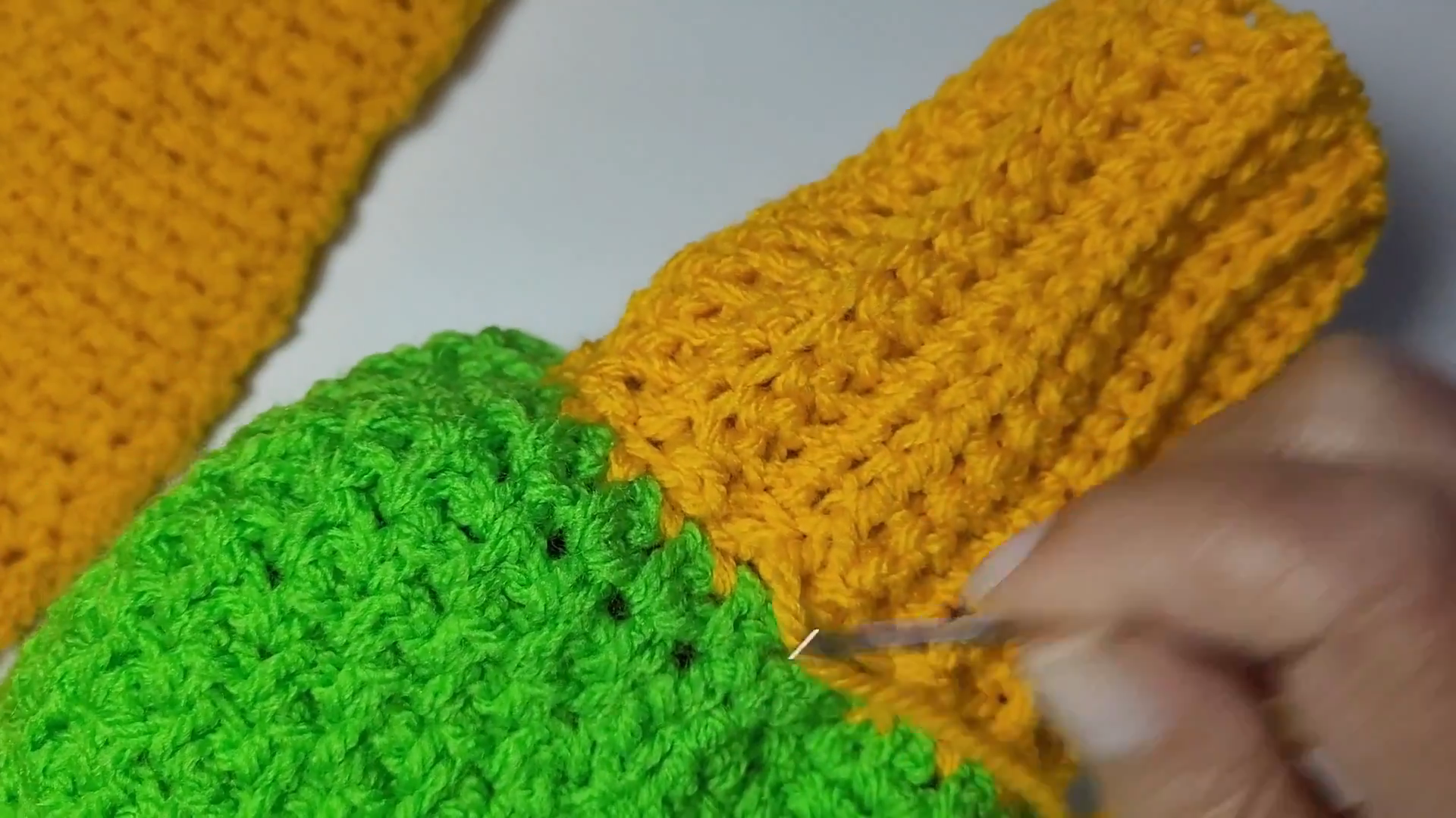 Sewing the yellow and green sections together along the sleeve edge